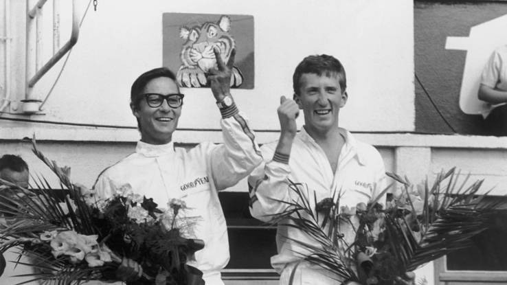 Surprise winners Masten Gregory and Jochen Rindt on the podium, their win in Chinetti's Ferrari 275 LM likely because some gripless experimental Goodyear tires, changed every hour, saved them from the transmission weakness of similar Ferraris that year. Photo by LAT
